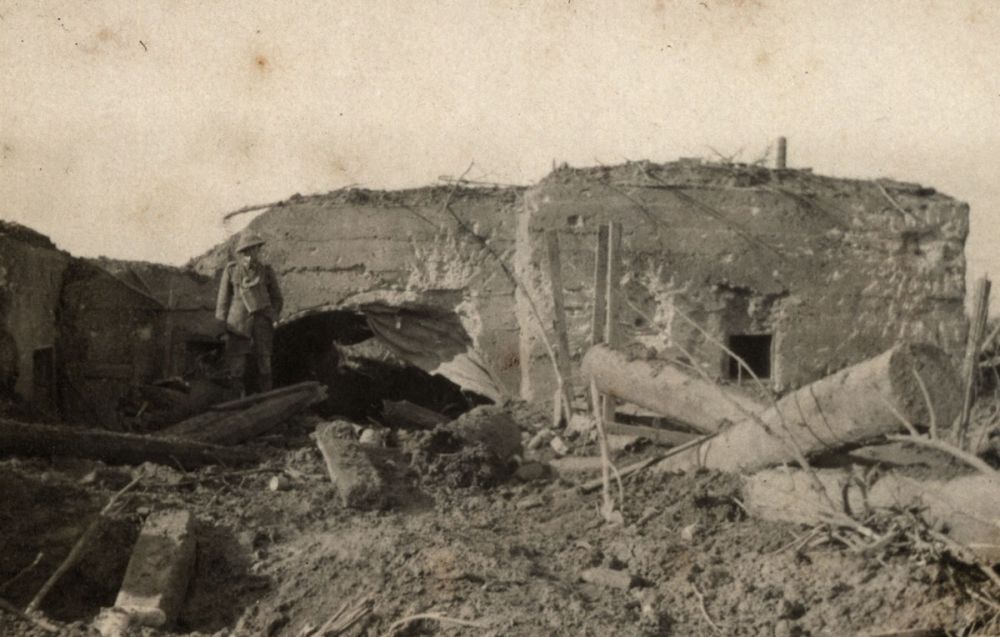 A New Zealand soldier stands outside a heavily shelled German bunker on Gravenstafel Ridge, Passchendaele. 